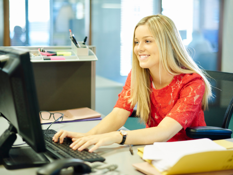 Image of a happy employee working at a desk